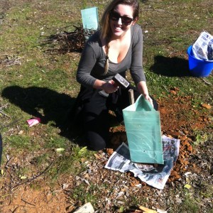 Hammering in a stake to stop the guard from swaying, while smiling for the camera.